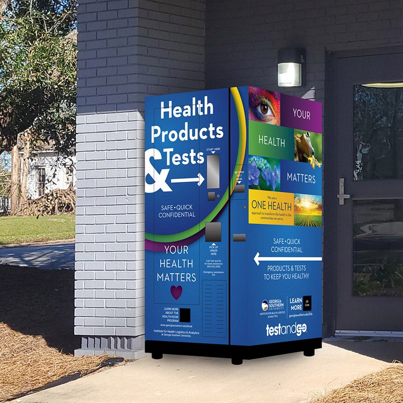 An example of a One Health kiosk installed near the entry of a building. It works like a UPS or FedEx drop-off box with One Health information screen printed on it.