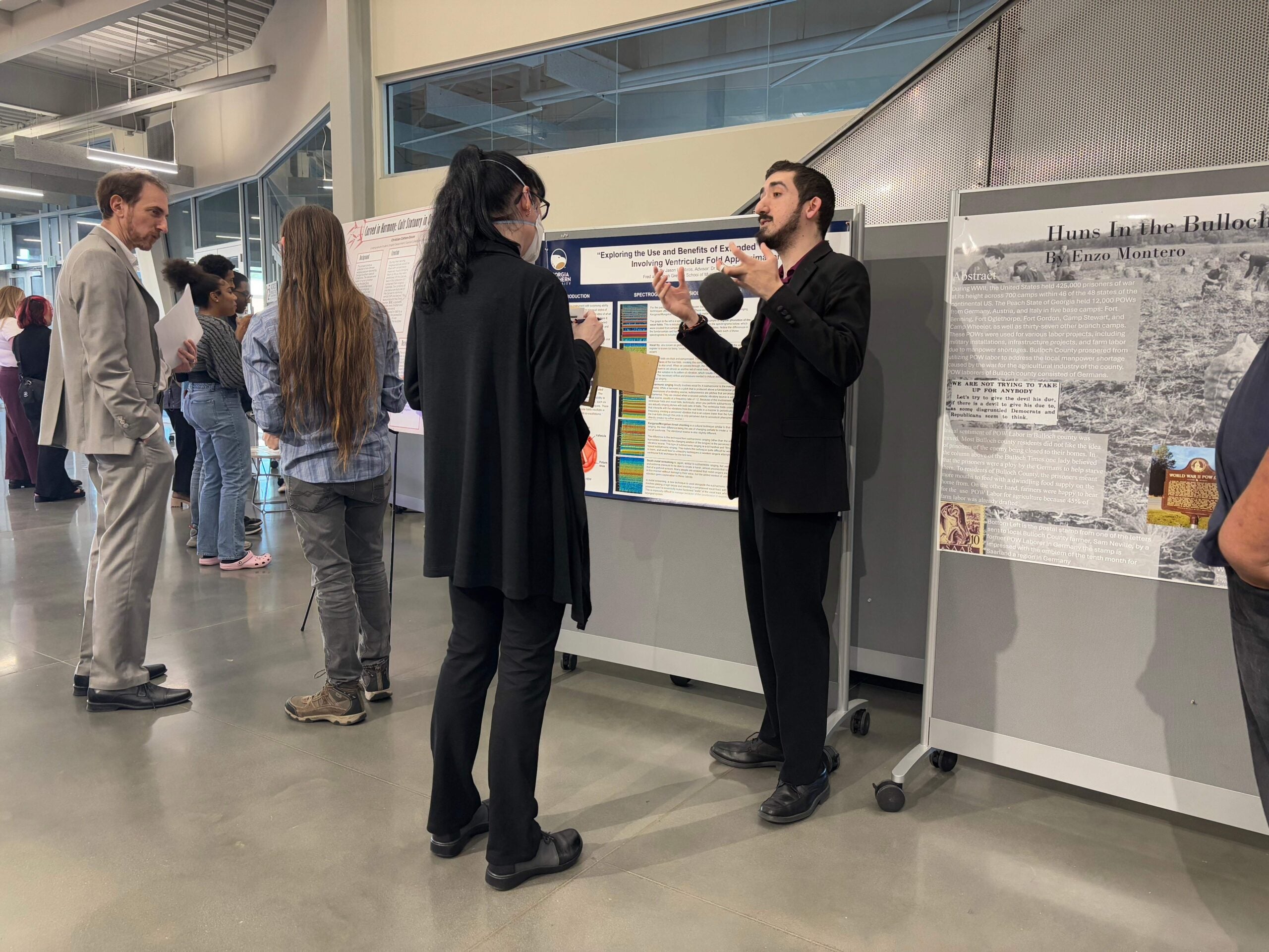 Georgia Southern University students present their research posters to judges during the 2025 CURIO Symposium.