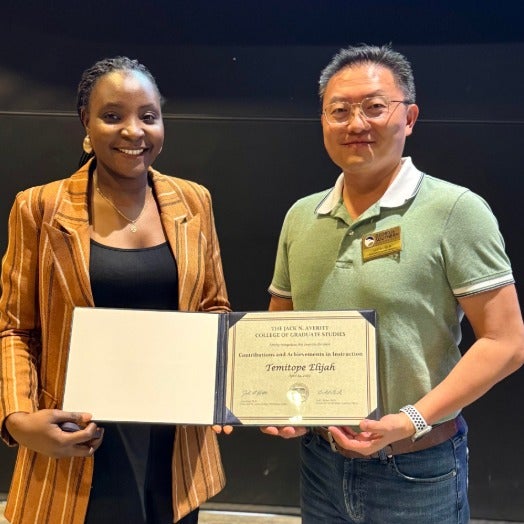Temitope Elijah shows off her award with Dr. Lei Chen.