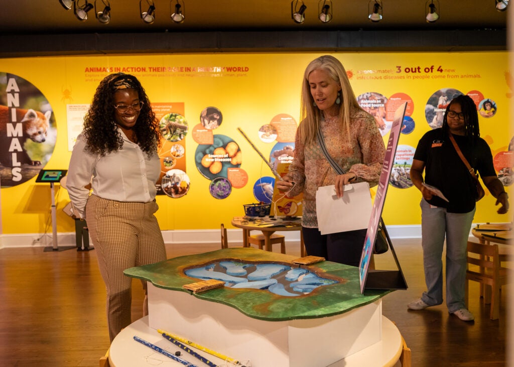 Visitors interact with One Health exhibit