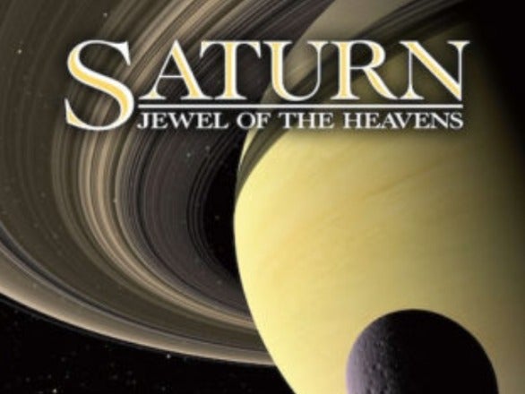 A poster for the planetarium show, Saturn, Jewel of the Heavens, features a large photo of saturn and its massive ring system with one of its many moons in the foreground.