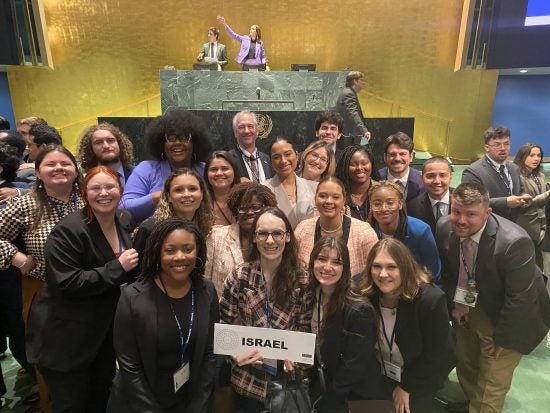 A group of students holding a sign that says Israel.