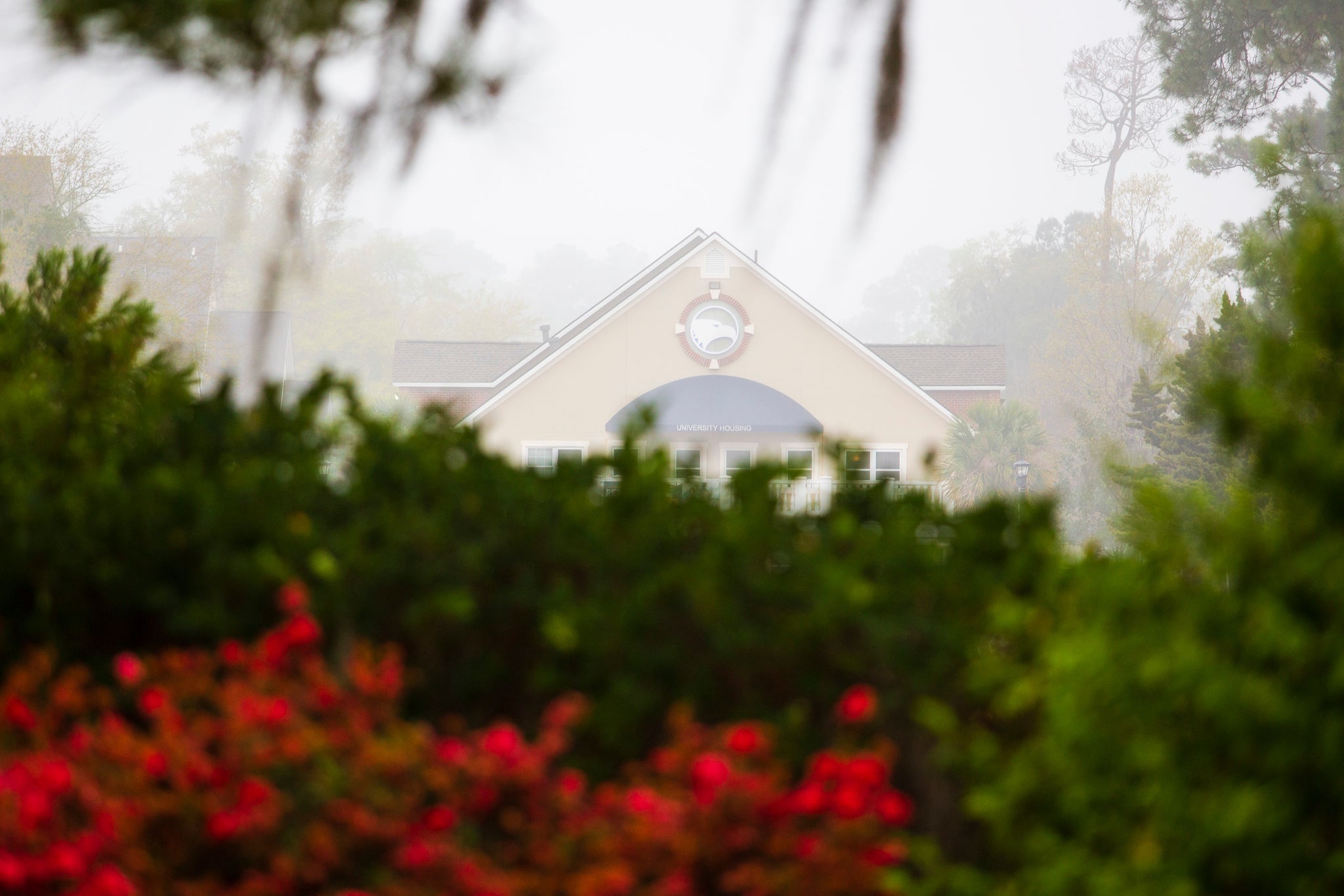 View of a Georgia Southern housing office with flowers and foliage in front