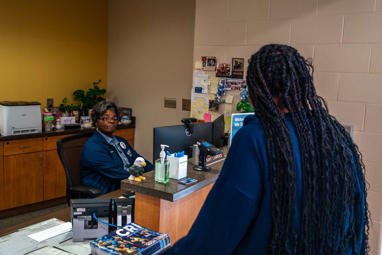 A Georgia Southern CRI Recreation center faculty checks a student in for intramural sport at the front desk.