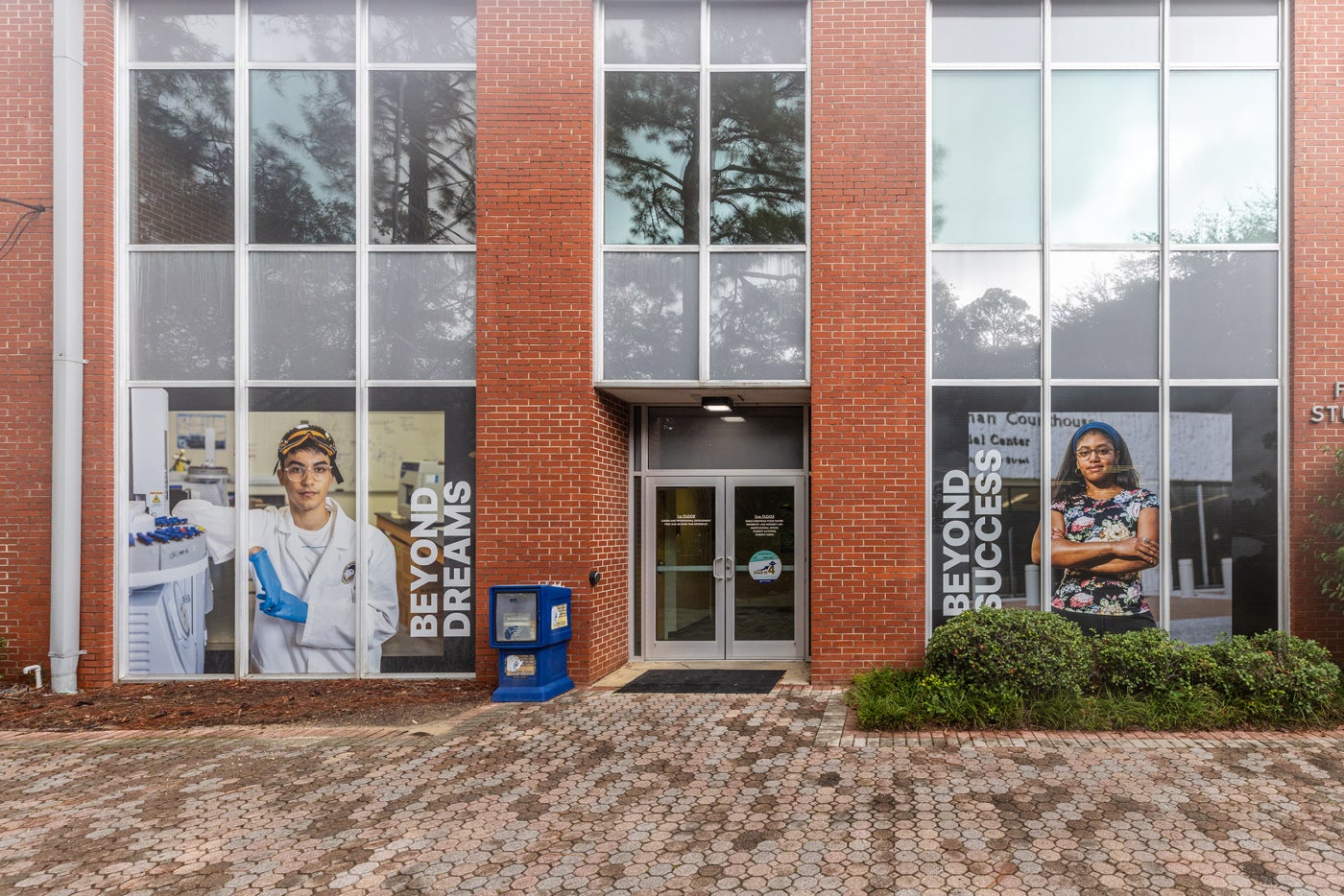 Williams Center windows show Soar Beyond banners with students in lab and legal settings, reading 'Beyond Dreams' and 'Beyond Success.'