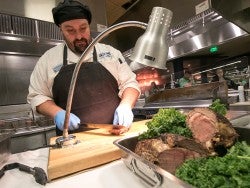 A chef works at the carving station at a Georgia Southern dining hall on campus to provide students with a healthy meal.