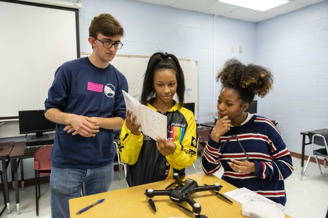 Wayne Johnson, Ph.D., examines a drone with mechanical engineering student Lydia Poole. Drones like this one will be used during the 2020 Engineering Design Challenge.