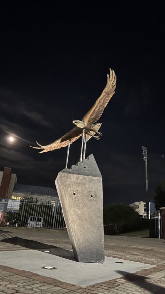The statue itself is under 400 pounds and the base weighs roughly 6,000 pounds. It is meant to resemble "Freedom's Flight," which took place before each home football game.