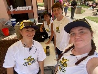 Eagle students at a first aid station while providing care for the 2025 Banana Ball Tournament.