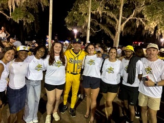 Eagle students pose with a Banana Ball player following an event at Grayson Stadium in Savannah, Georgia.