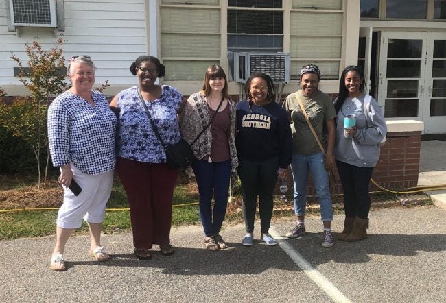 From left to right, Associate Professor of Anthropology, Heidi Altman, Ph.D., and students, Angelique Jennings, Miranda Hazelwood, Mpume Hlophe, Michaela Guilfoyle and Ahmauri Williams-Alford pose for a picture before the COVID-19 pandemic. Altman and her students have volunteered at the Willow Hill Heritage and Renaissance Center for several years.