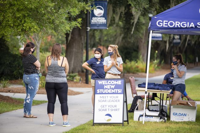 SOAR leaders pictured with new students as they welcome them on campus at Georgia Southern University.