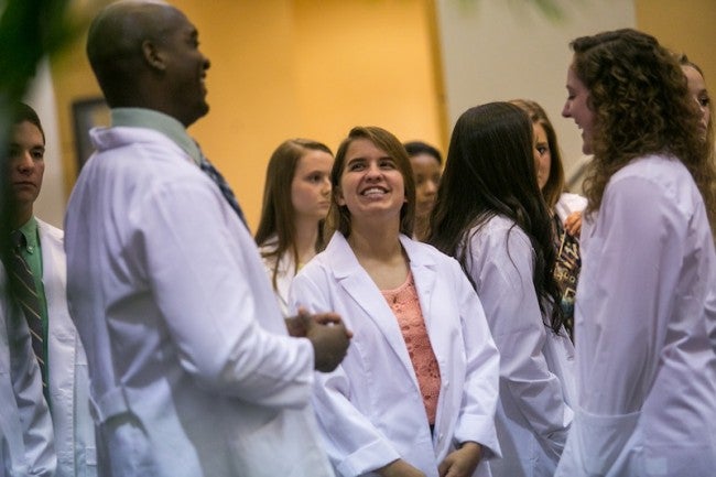 Students from the Georgia Southern University School of Nursing chat after donning their white coats during the University's inaugural White Coat Ceremony on Friday, Sept. 19 at the Performing Arts Center. The White Coat Ceremony was initially designed by The Arnold P. Gold Foundation (APGF) to emphasize the commitment of patient-centered care for incoming physicians to medical school. More than twenty years later, nurses are now a part of the tradition.
