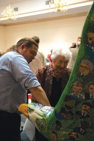 Eagle Nation on Parade designer Scott Foxx talks with Roxie Remley about the “Bulloch County Family Tree” eagle that will be installed on Sept. 25 at the Statesboro Regional Library. 