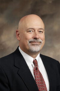 Will Lynch wearing a suit and tie