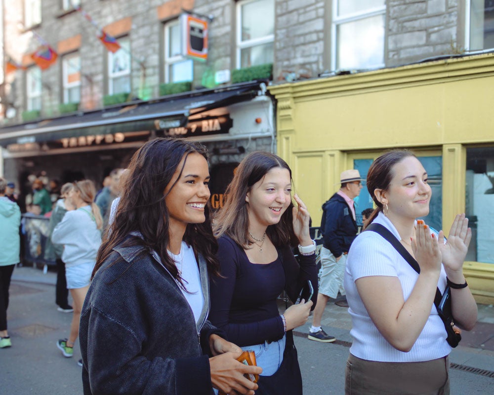 Group of Georgia Southern students walking down a crowded shopping area in Ireland.