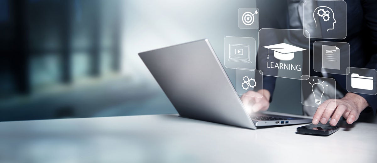 Concept of Online education and teaching. Person using a laptop for Online education.