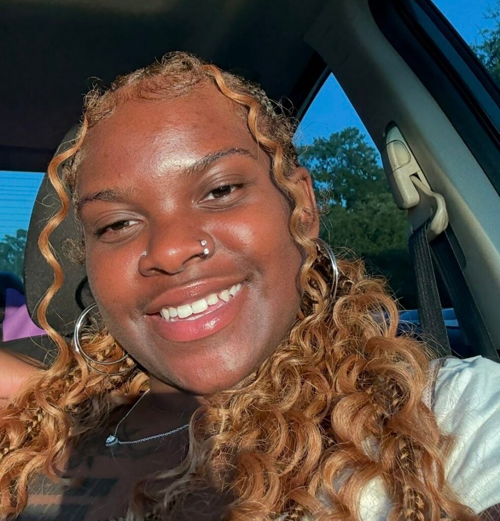 Radiation therapy student Ariyana Braxton poses for a selfie in the sunlight with a warm smile