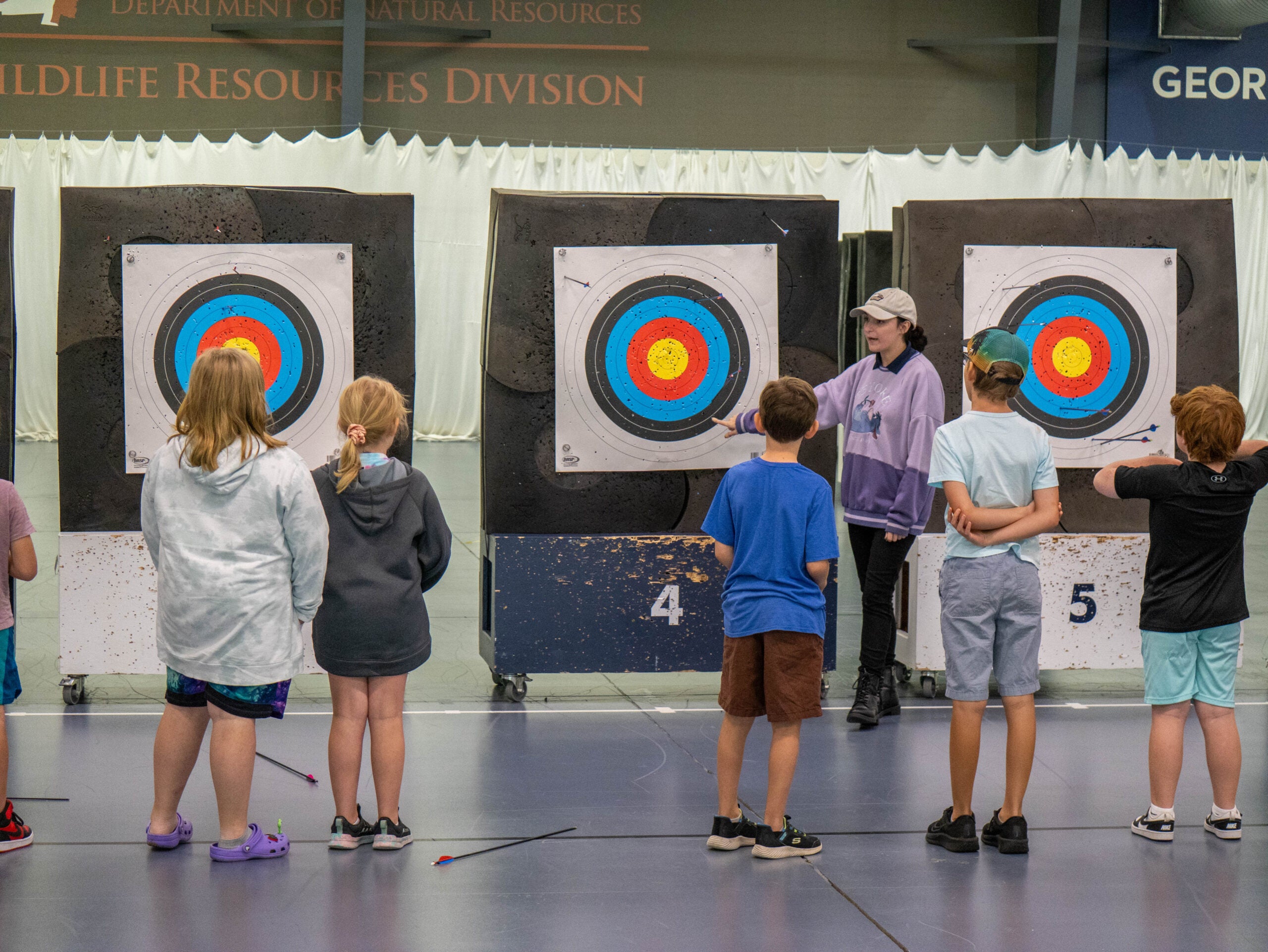Kids watching instructor at the Shooting Sports Summer Camp