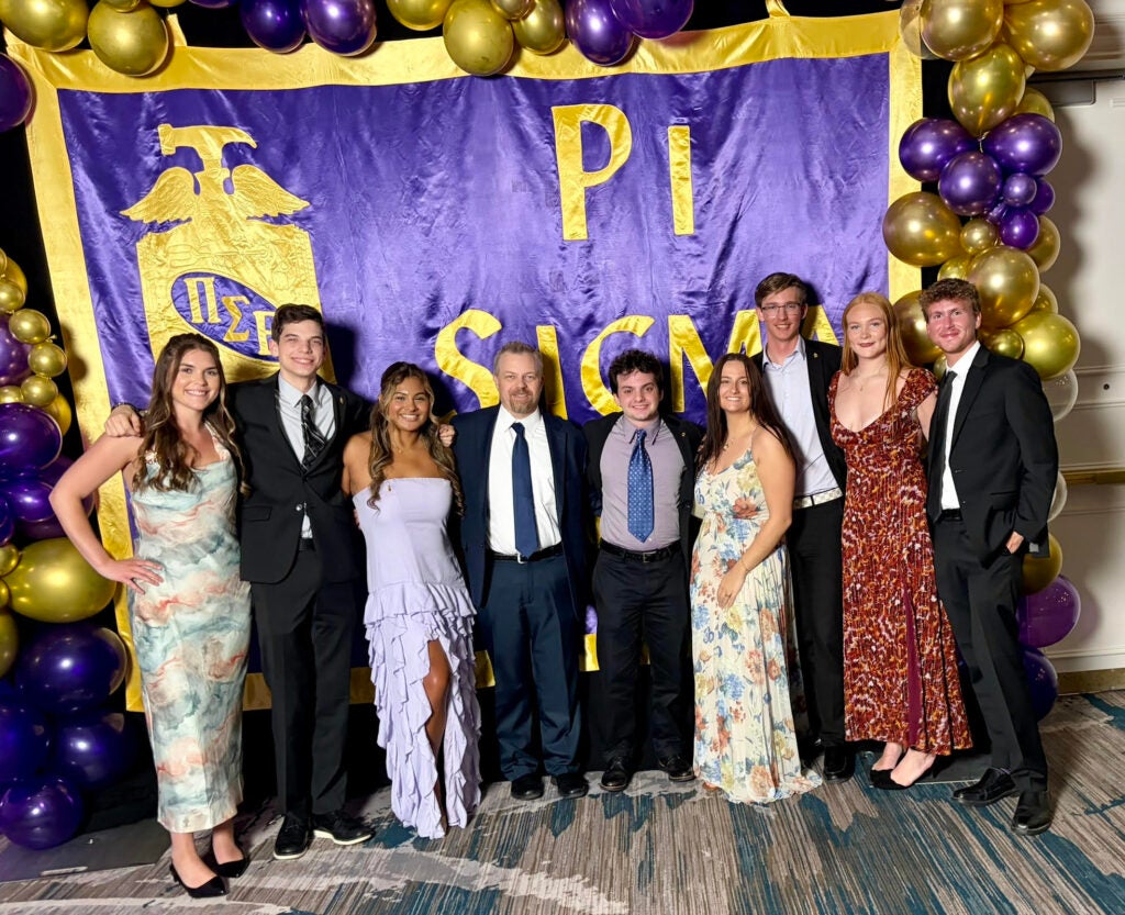 Georgia Southern students from the Parker College of Business stand with Professor Travis Brickey at the Pi Sigma Epsilon National Convention