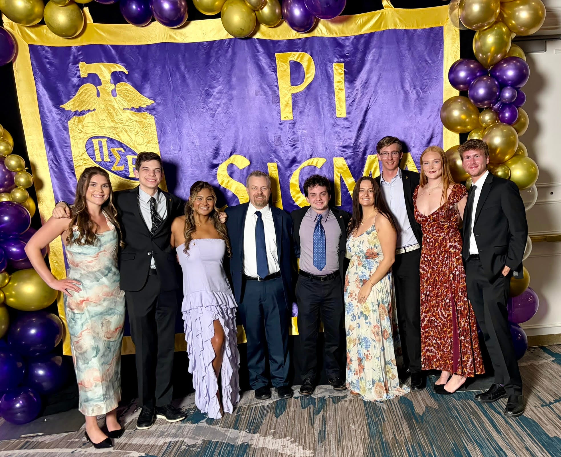 Georgia Southern students from the Parker College of Business stand with Professor Travis Brickey at the Pi Sigma Epsilon National Convention