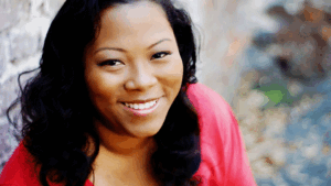 A woman smiles at the camera