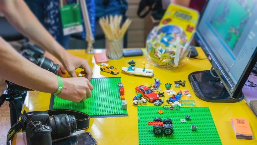 Photo of a pair of hands building legos