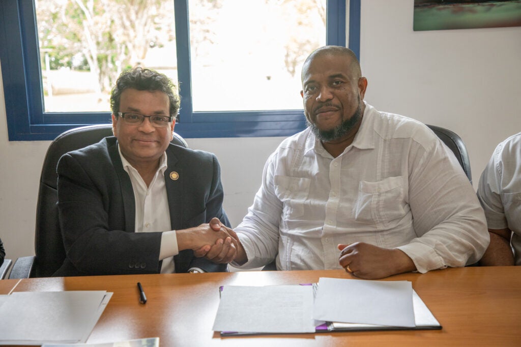 Provost Mukherjee and President Palacio shake hands during a signing ceremony