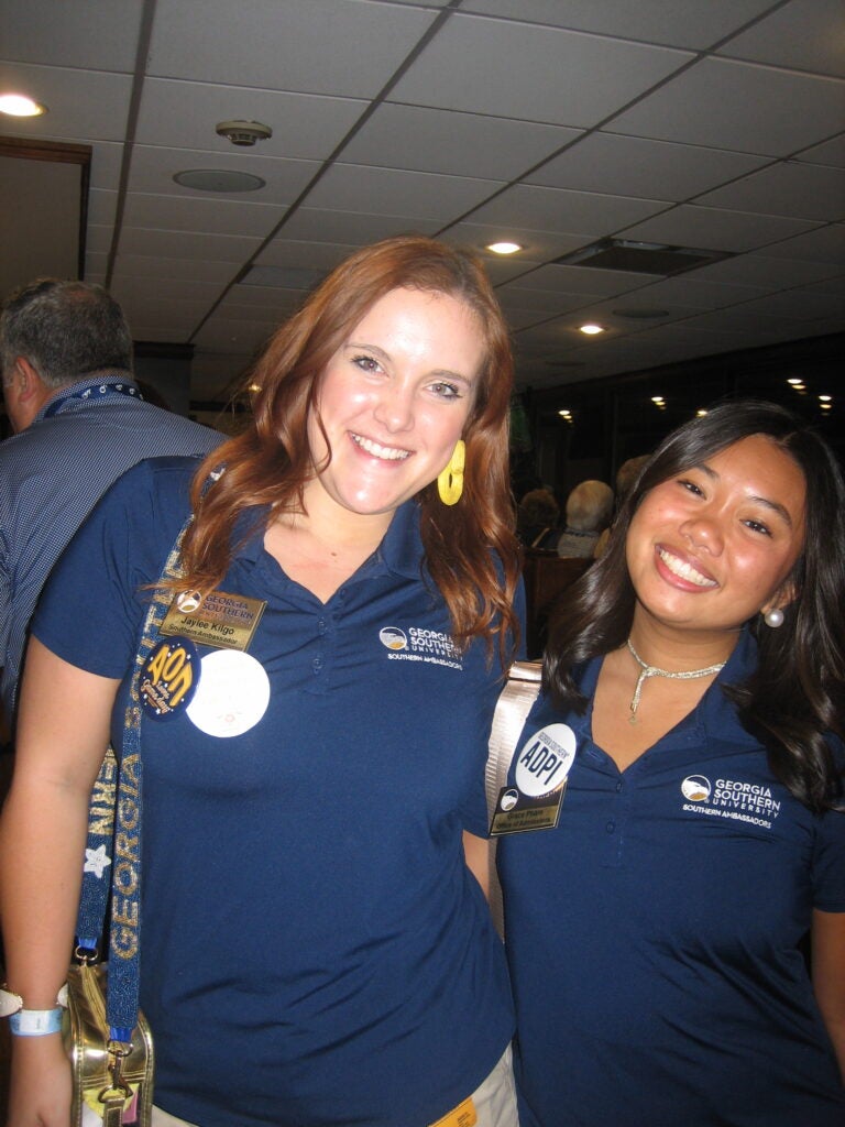 Jaylee Kilgo and a fellow Southern Ambassador pose together wearing branded polos.