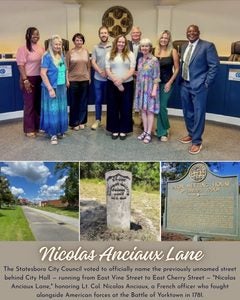 A collage shows a gathering of Statesboro city council at the top, a streetscape of the newly named Nicolas Anciaux Lane, a stone marker bearing Anciaux's name and a historic plaque telling Anciaux's story
